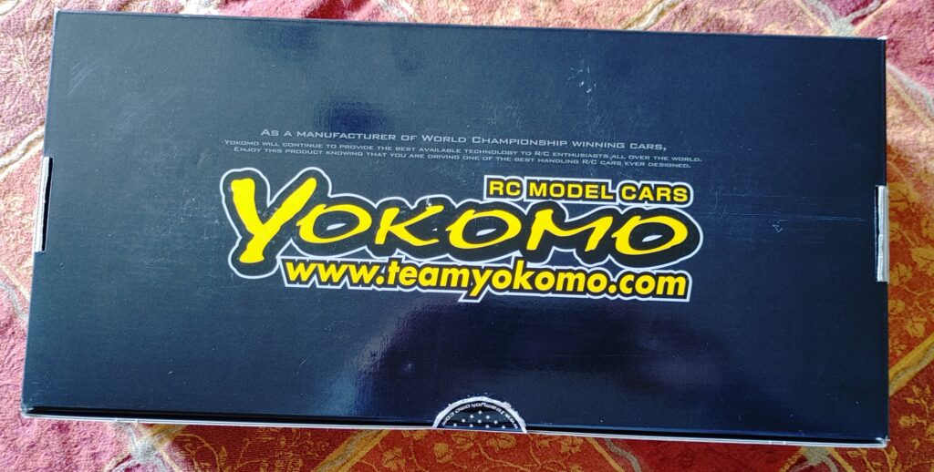 Box for a Yokomo drift RC car kit. The box is black and yellow. 